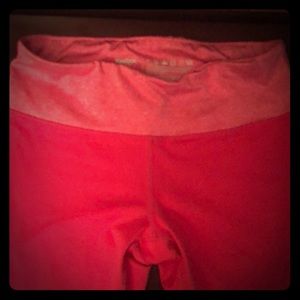 Pinkish/reddish color Reebok Capri length.